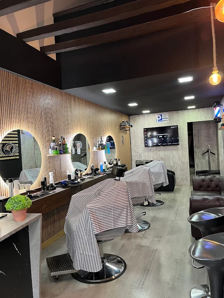 Interior de Gentleman The BarberShop en Aravaca, con puestos y sillones de barbería
